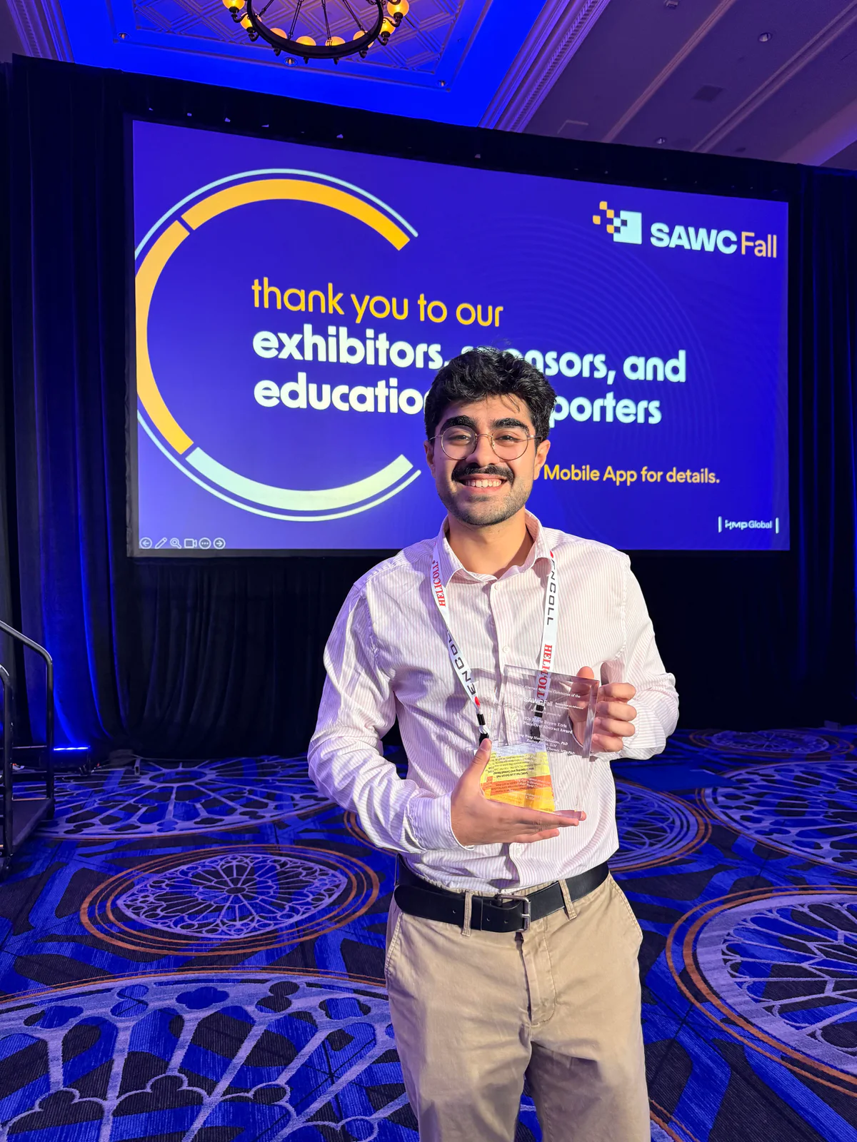Roshan Parikh holding the 2026 Marie Brown Etris 3rd Place Oral Abstract Award at SAWC Fall